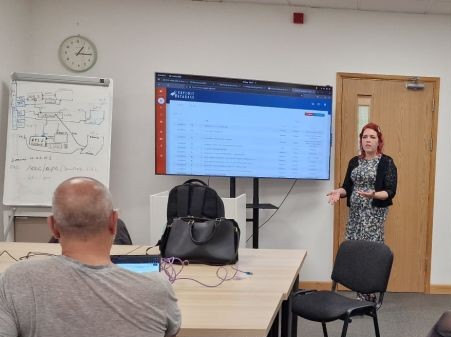 Elderly man standing by gate outside home